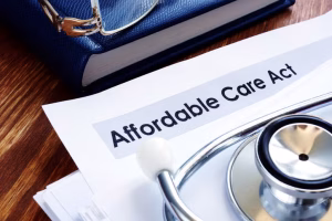 Paper, stethoscope, and glasses on a desktop